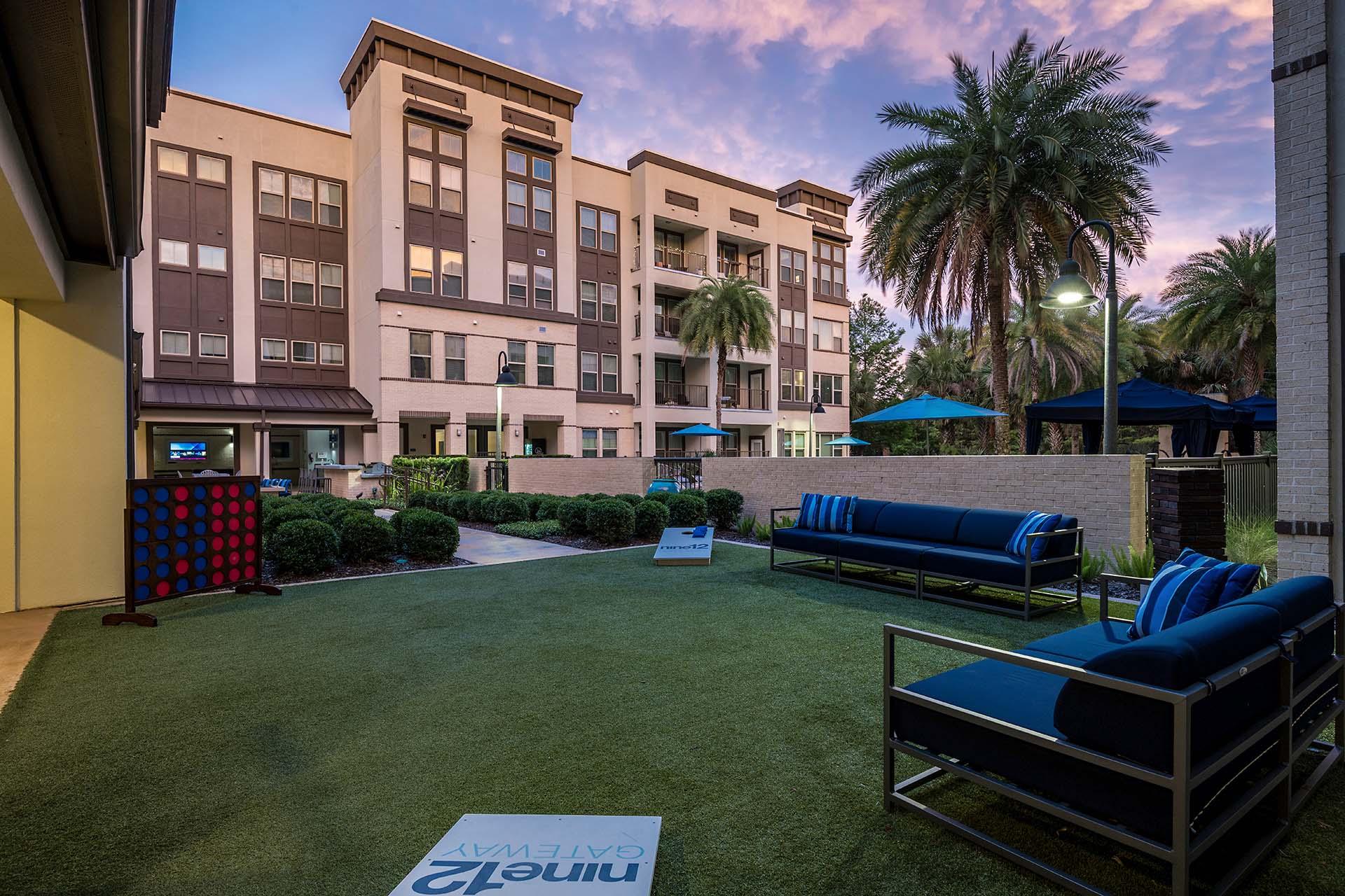 A grassy area with a sign that says "Clean" in front of a building.