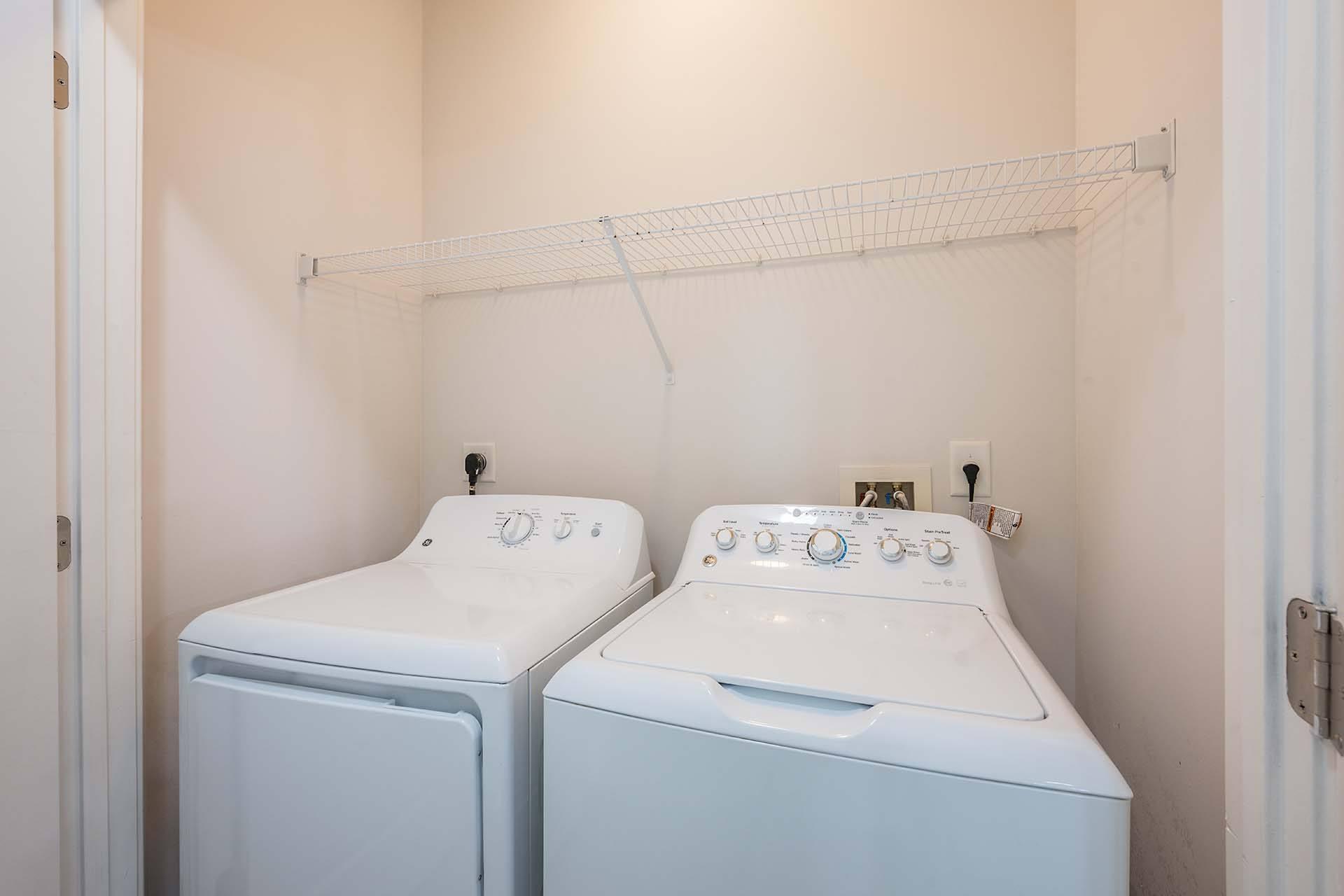 A small laundry room with a washer and dryer.