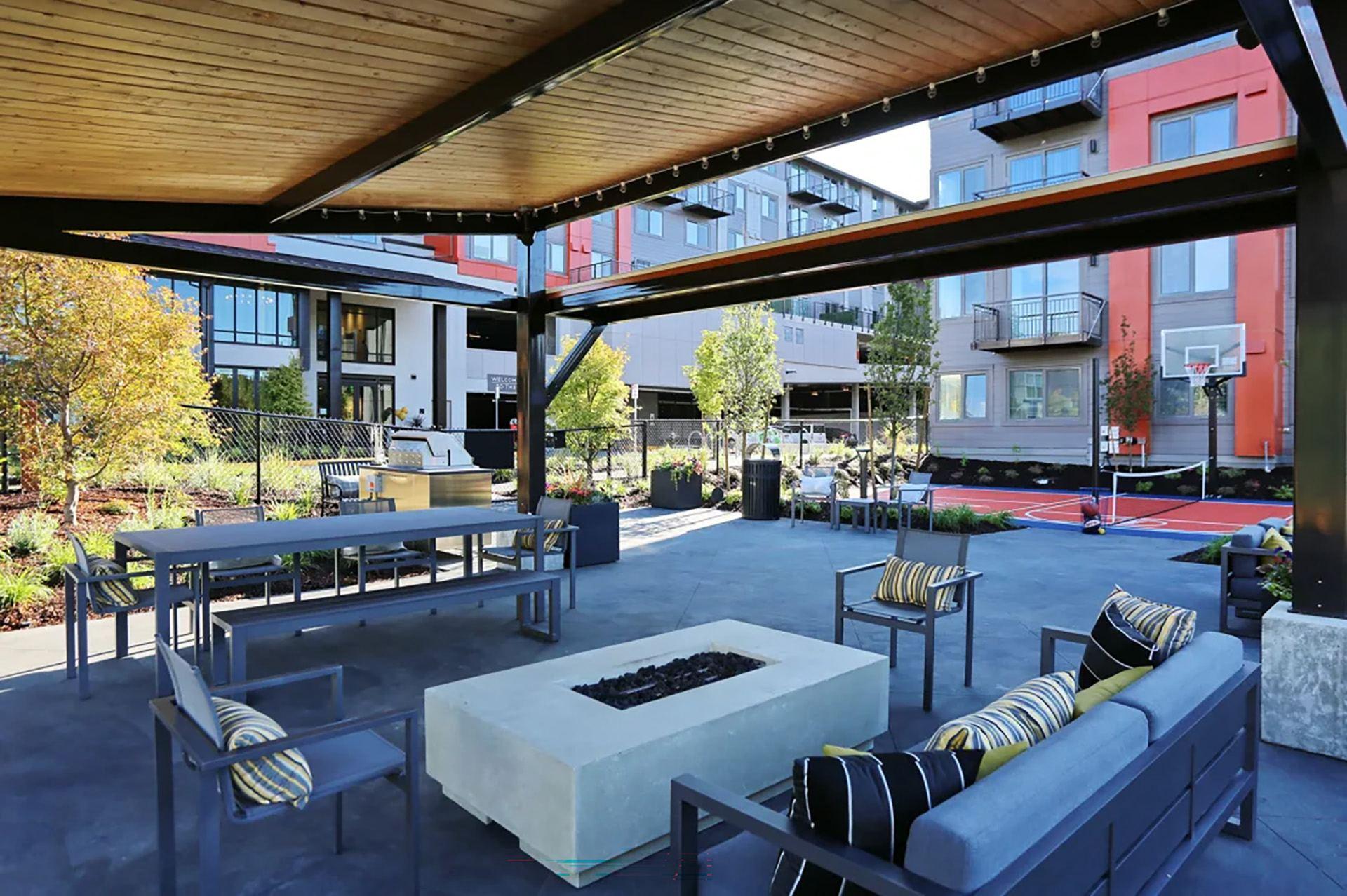 a rendering of a patio with furniture and a fire pit