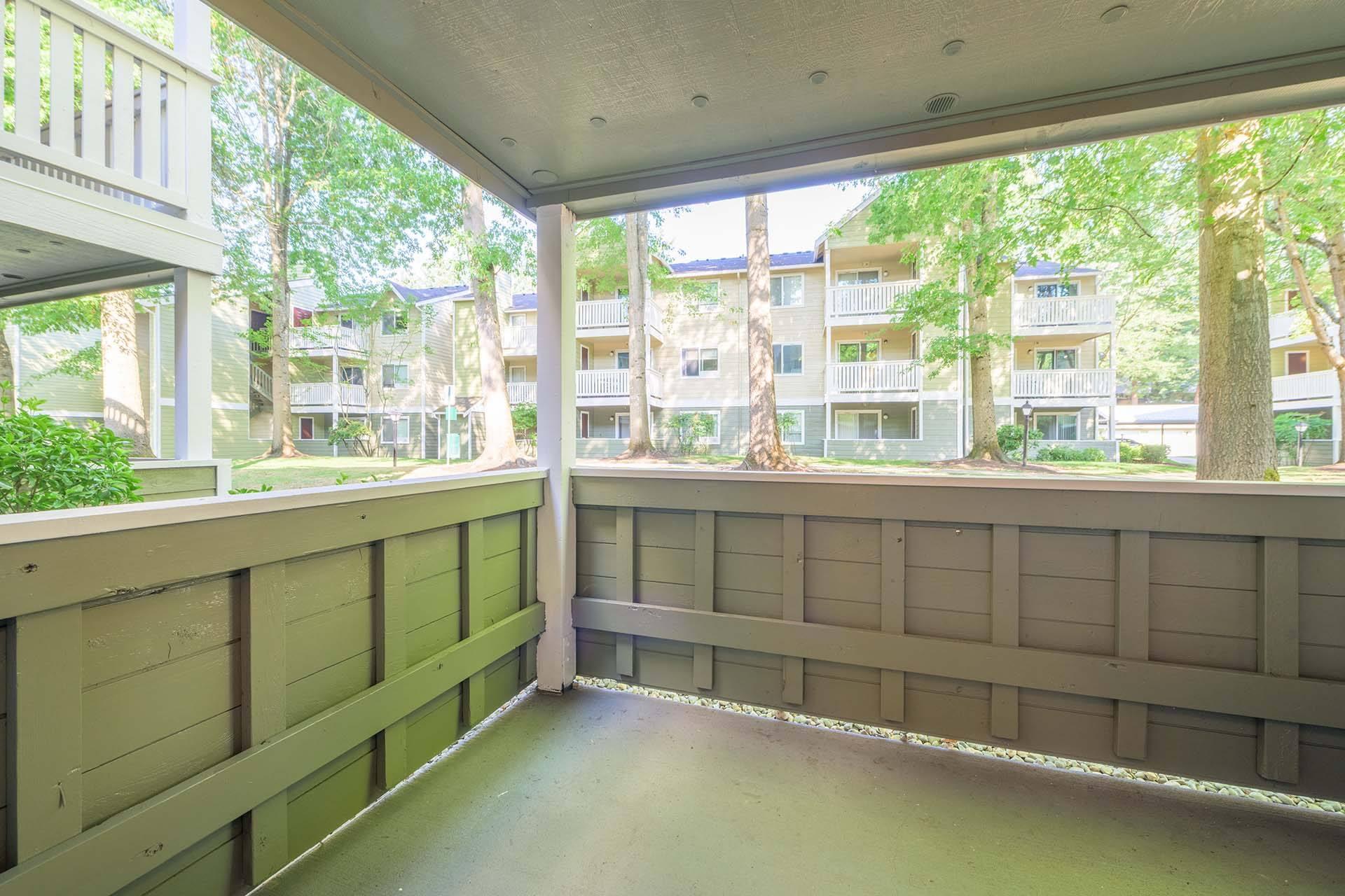 A balcony with a railing and a view of apartment buildings.