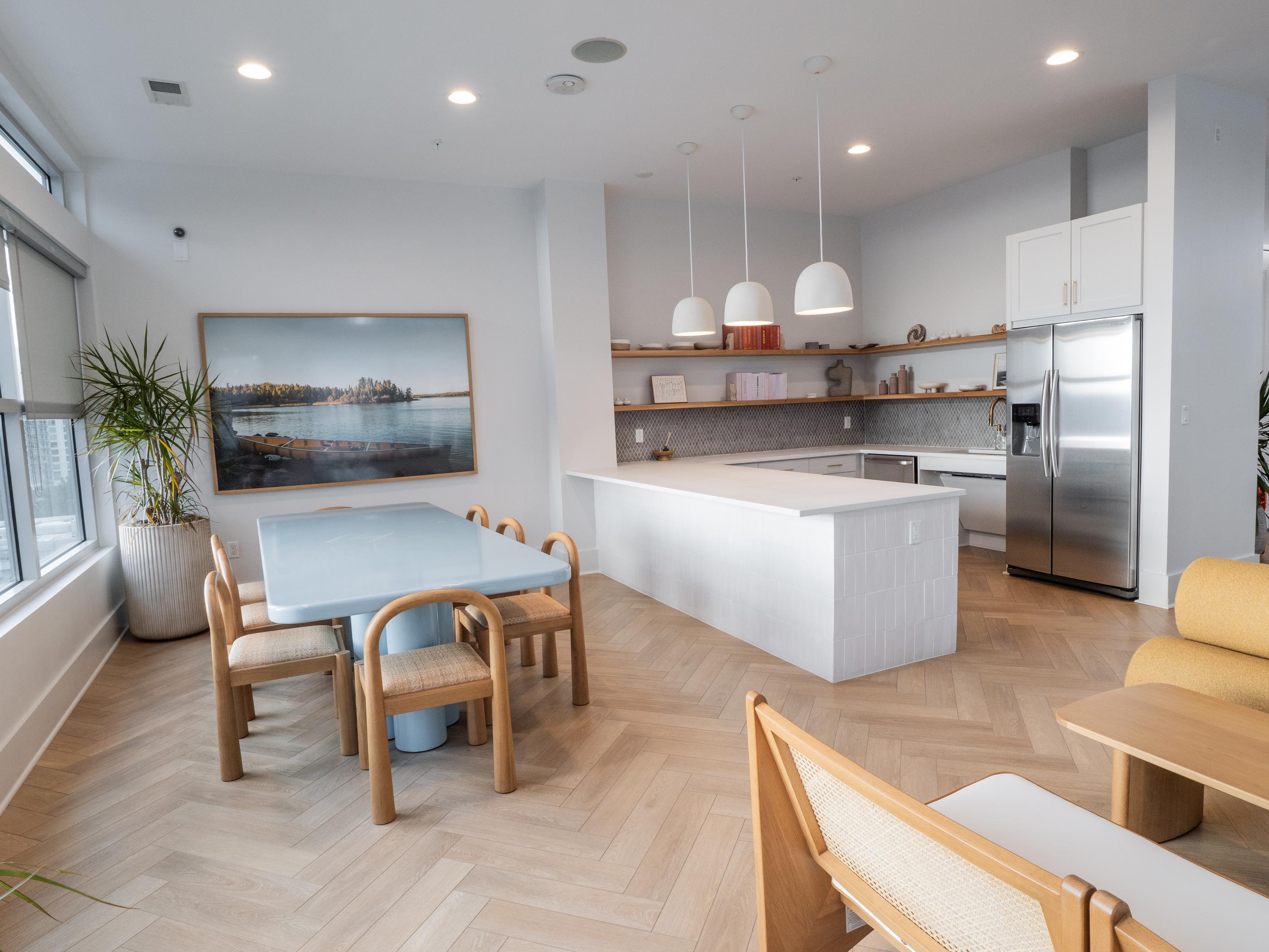 A modern kitchen with a dining table and chairs.