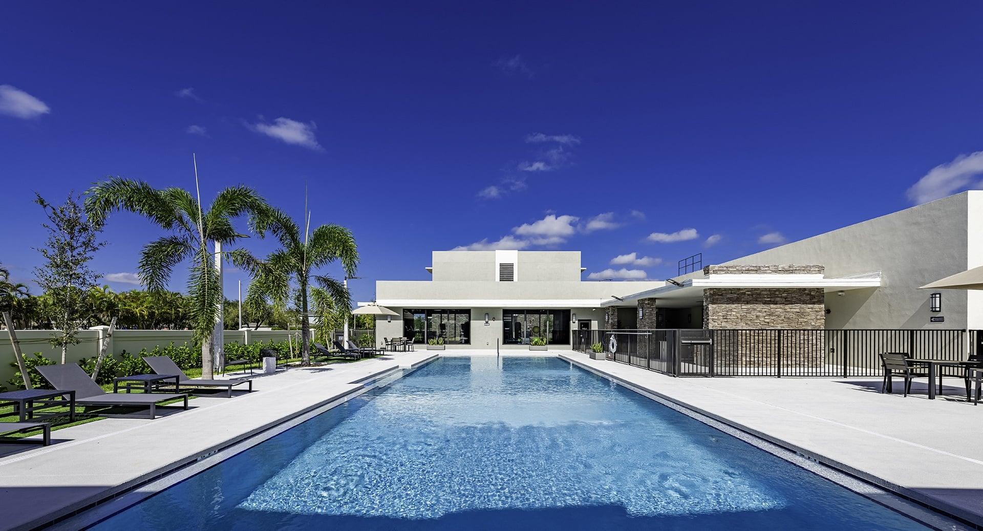 A modern house with a pool in the foreground.