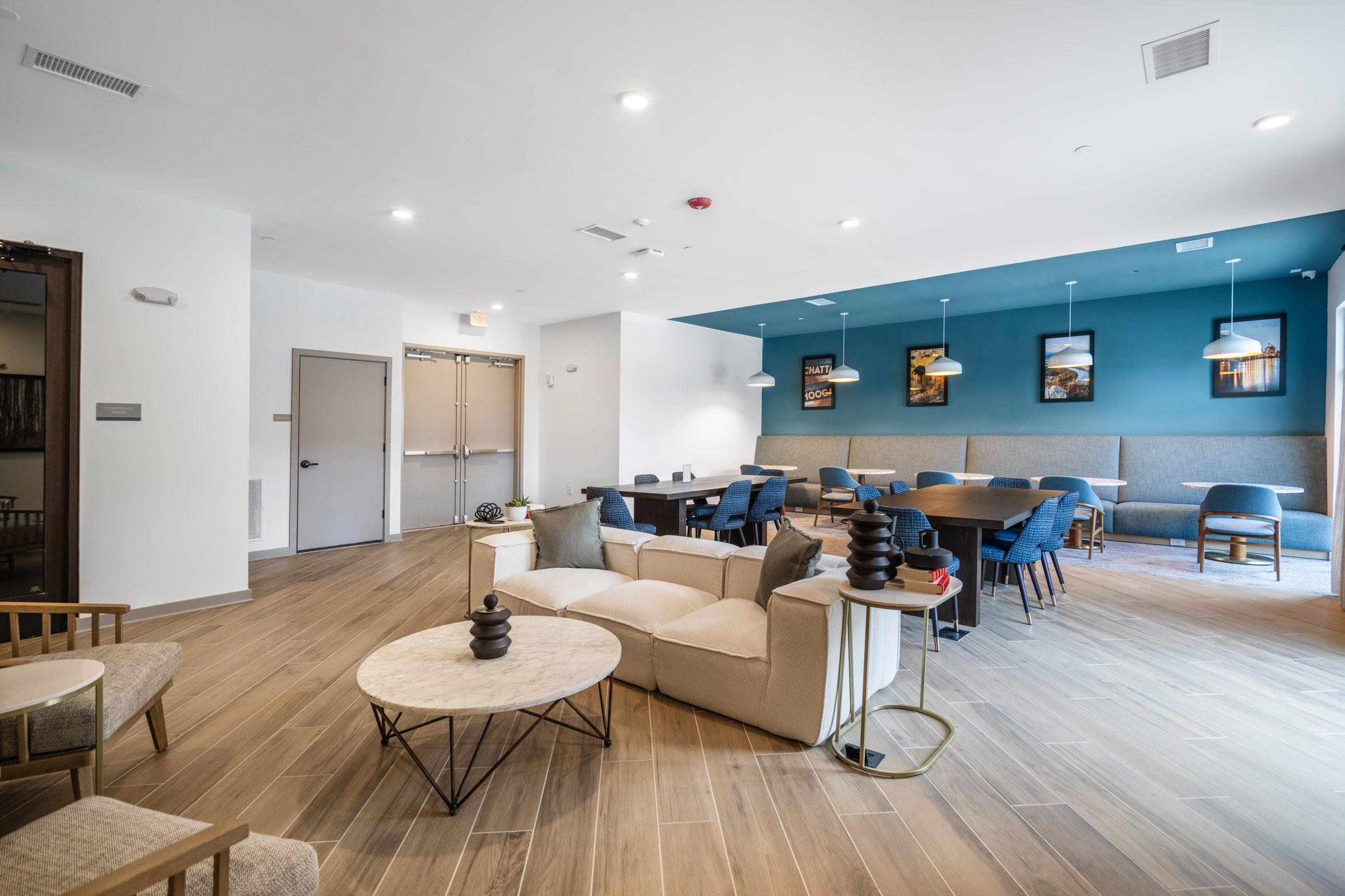 A modern living room with a white and blue color scheme.
