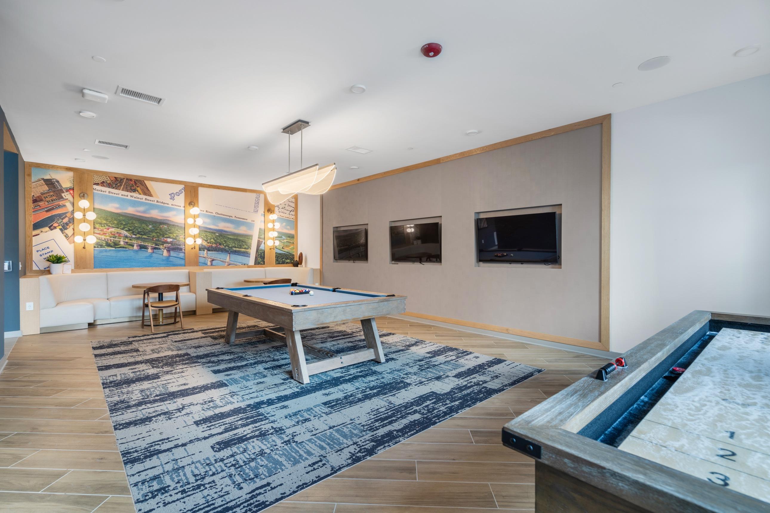 A billiard table is in the middle of a room with a pool table.