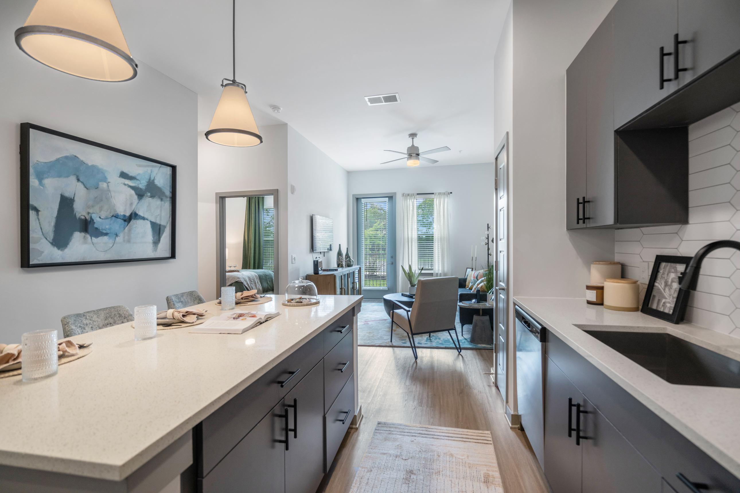 A kitchen with a table and chairs in the middle of it.