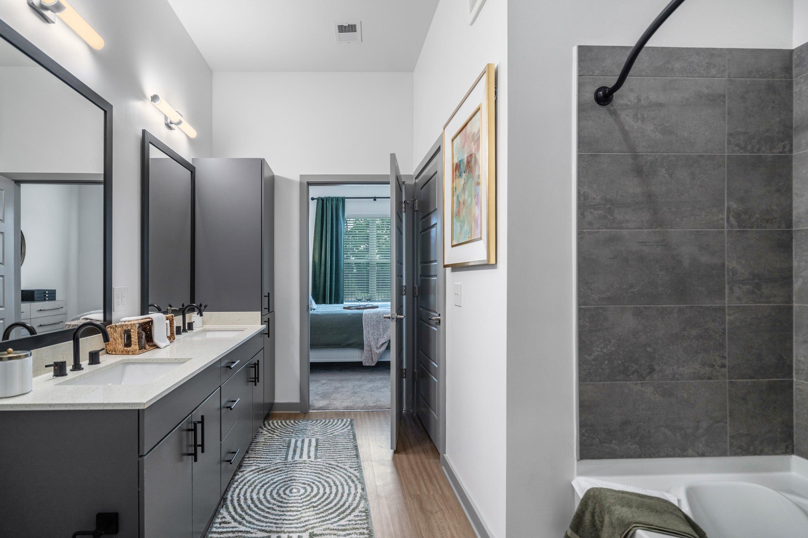 A bathroom with a white sink and a mirror above it.
