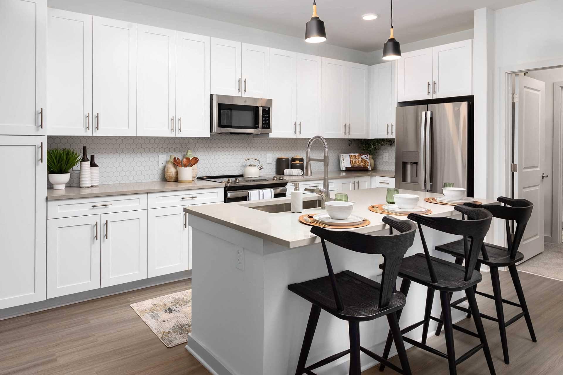 a kitchen with a center island and three stools