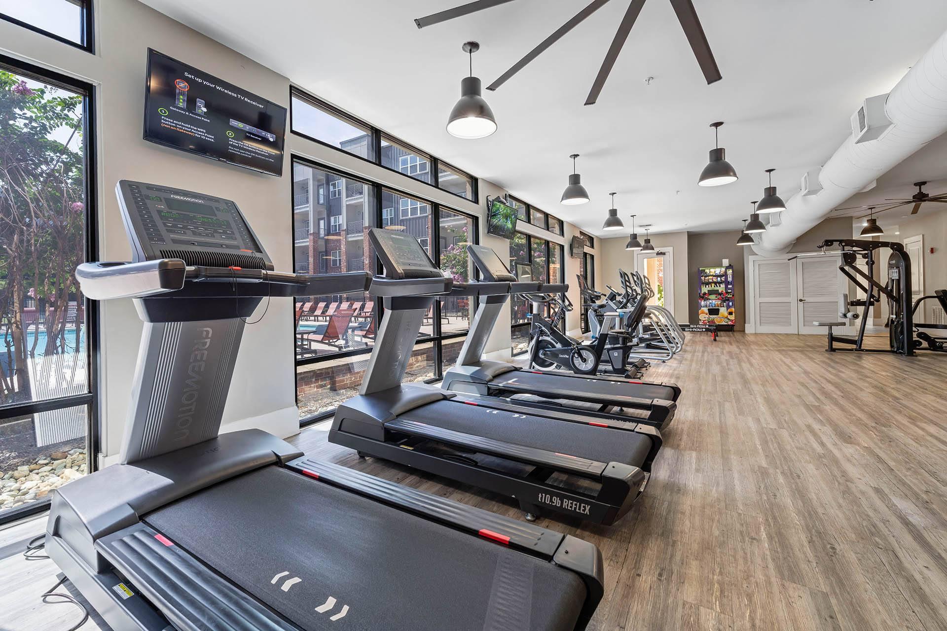 a gym with treadmills and other exercise equipment