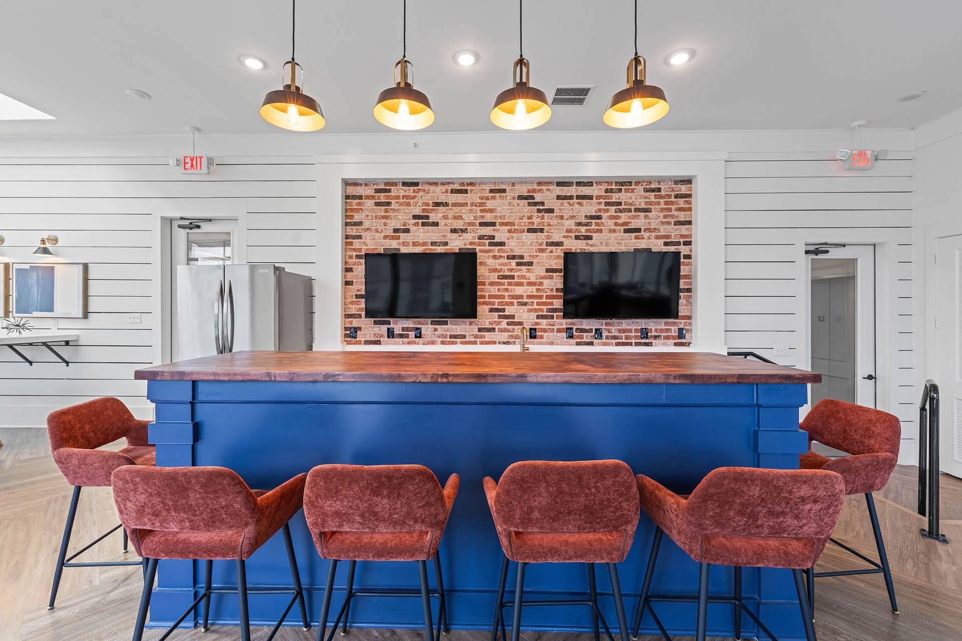 a kitchen with a blue counter and four chairs