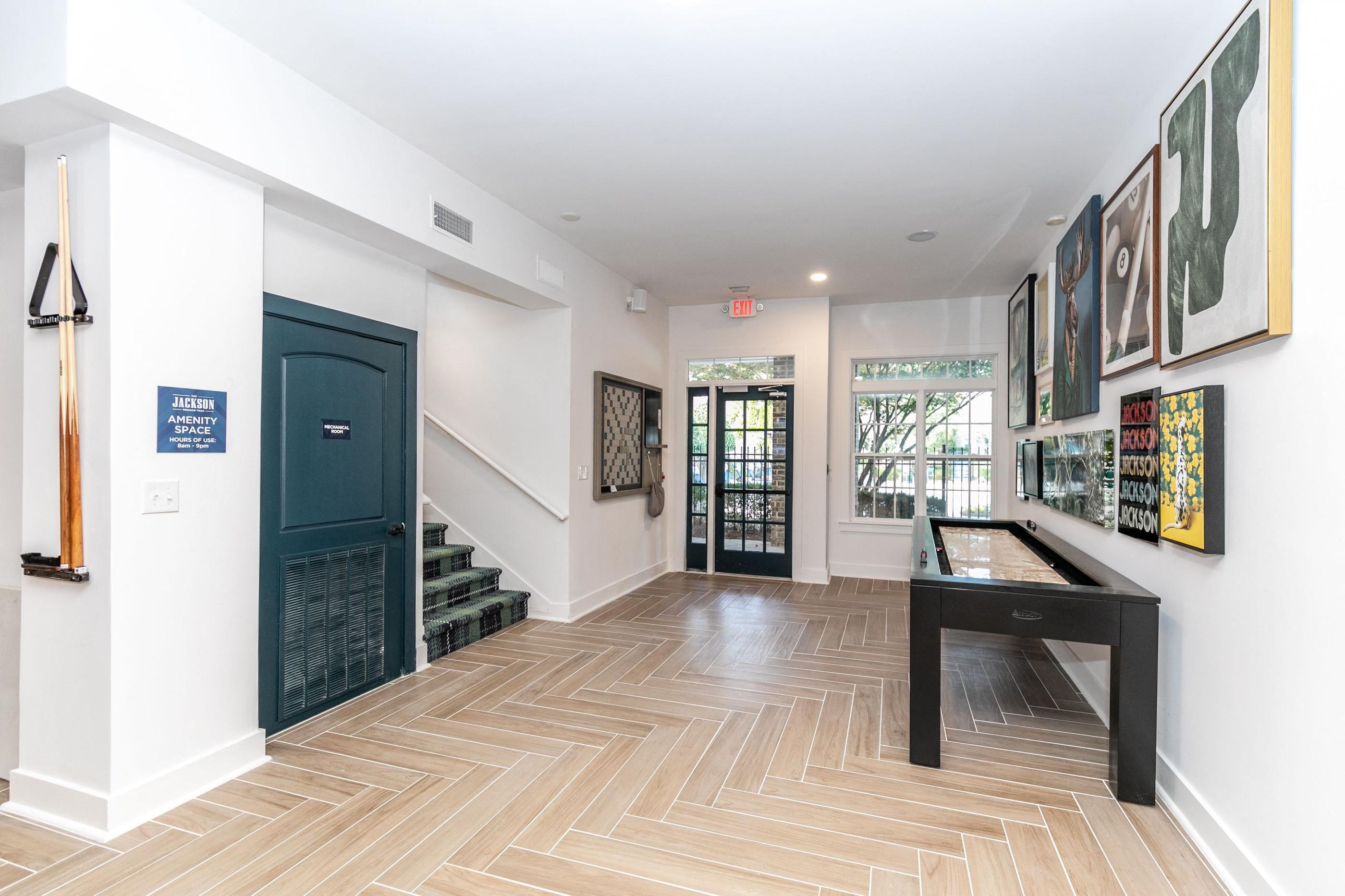 A hallway with a bench and pictures on the wall.