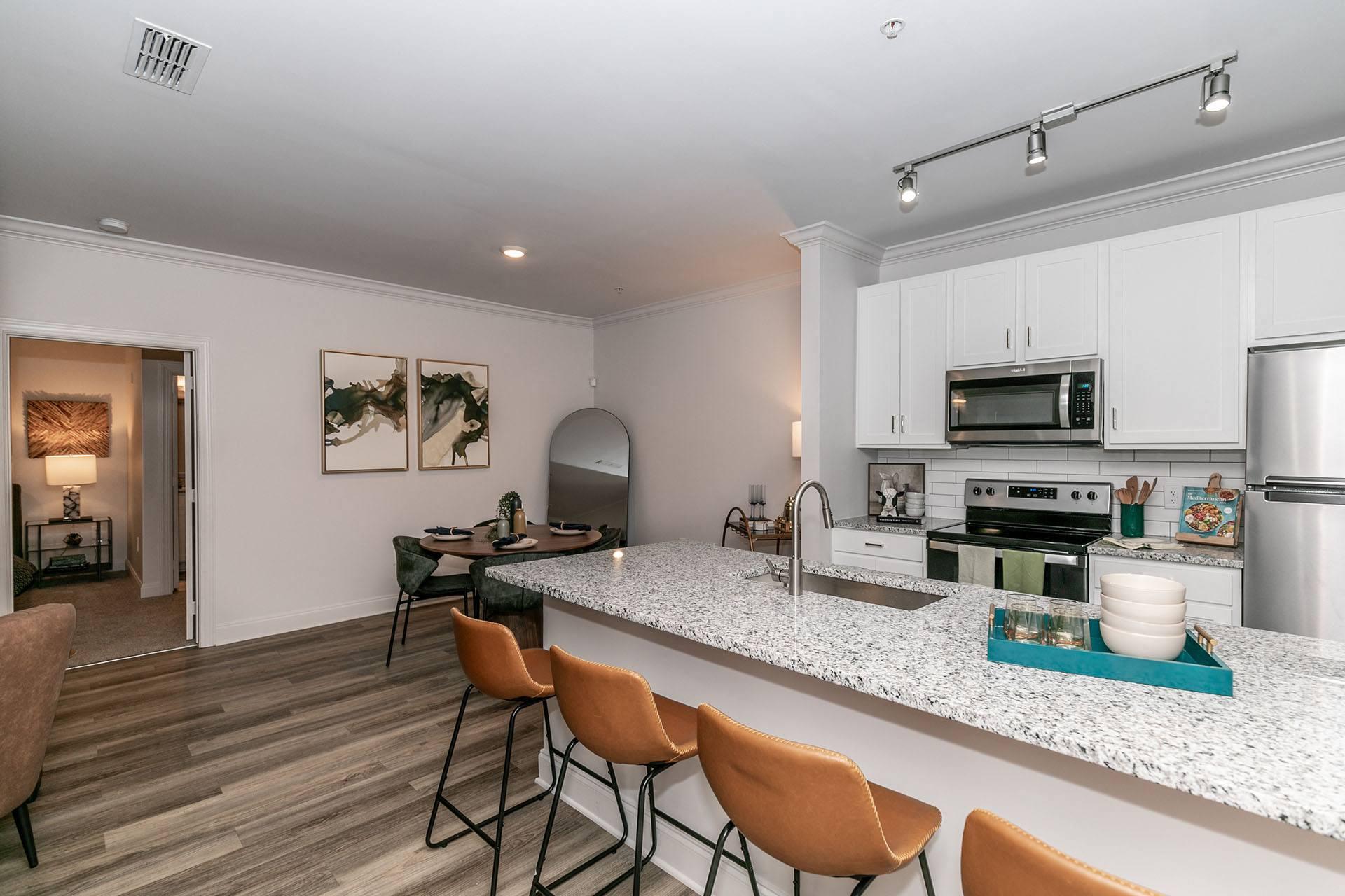 a kitchen with a marble counter top and a kitchen island