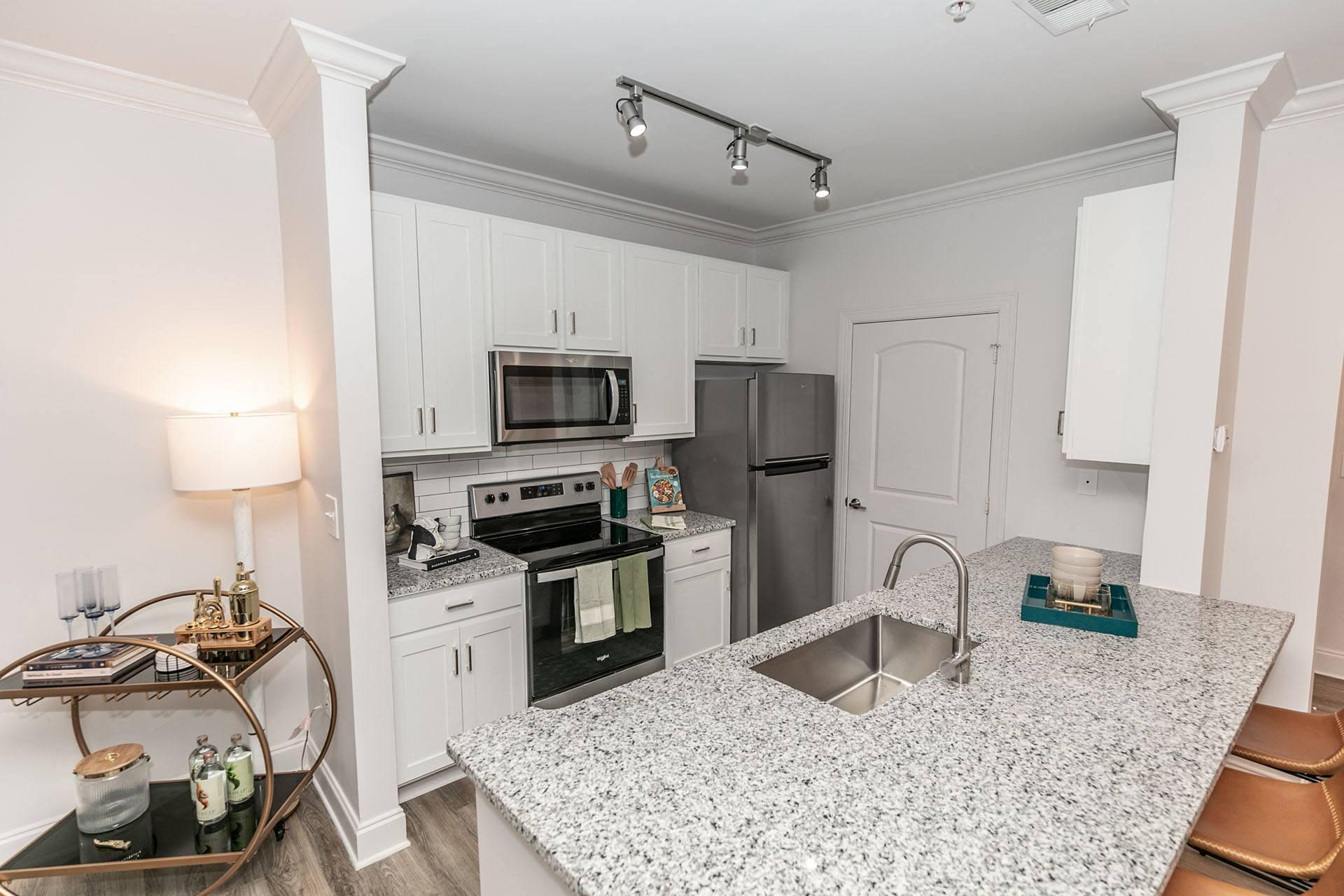 a kitchen with granite counter tops and stainless steel appliances