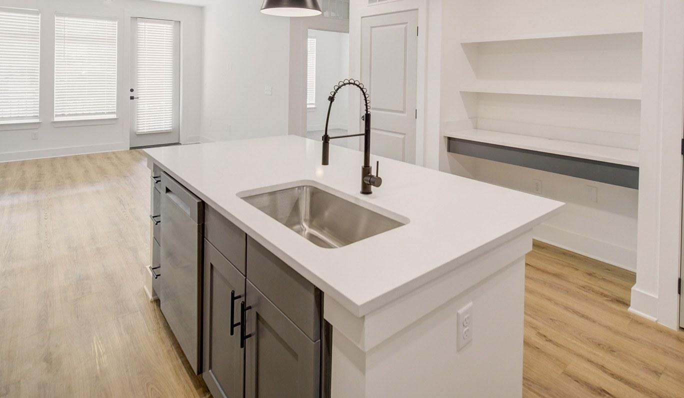 A kitchen with a sink and a countertop.