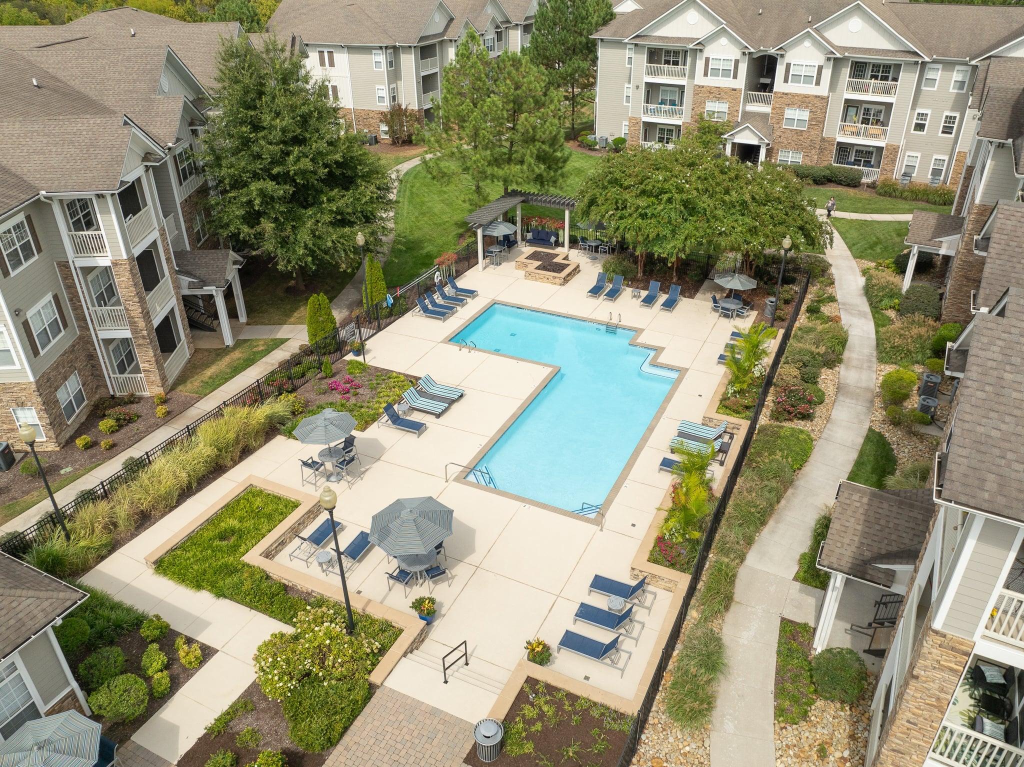 an aerial view of a swimming pool in an apartment complex
