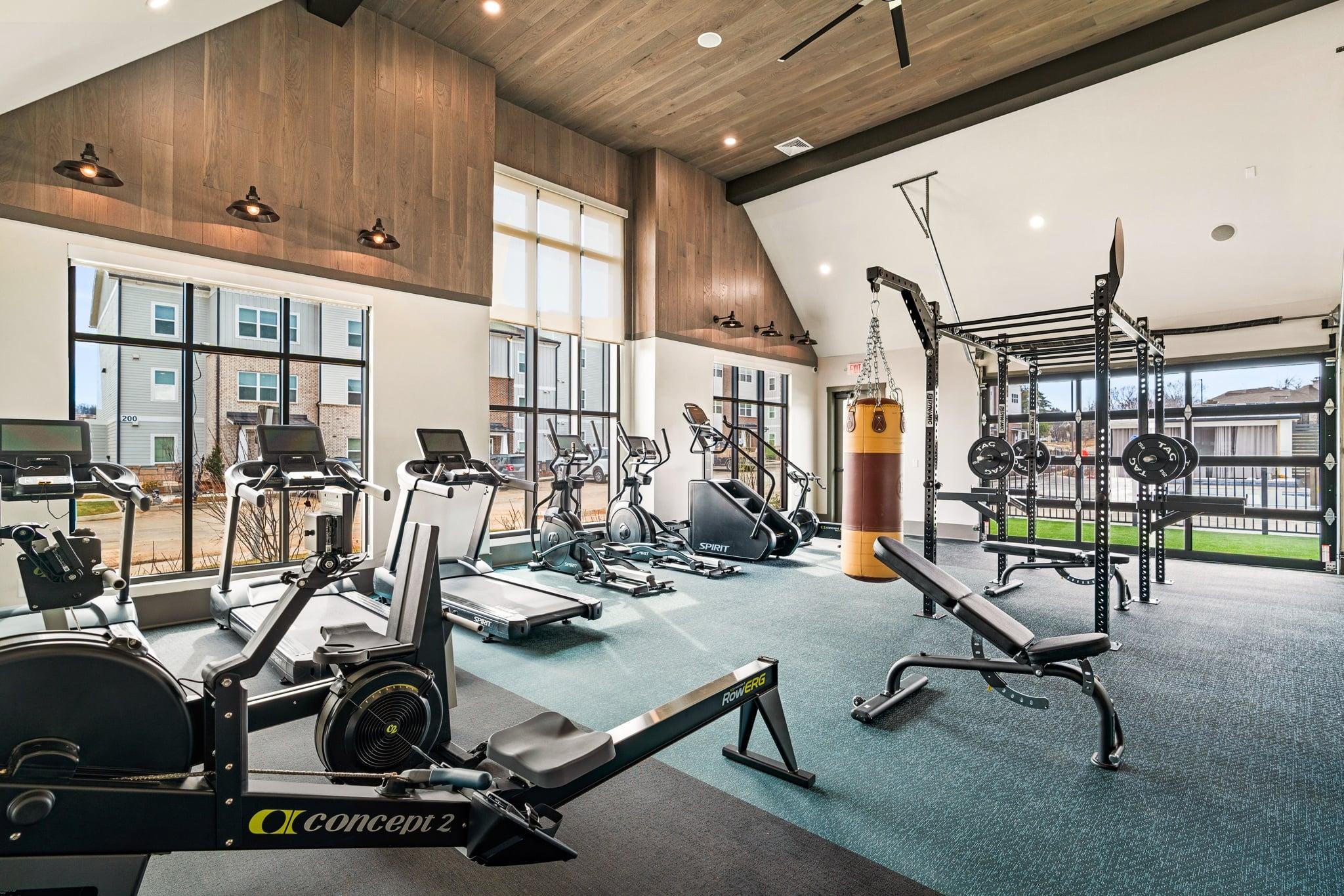 A gym with a variety of equipment including a rowing machine.