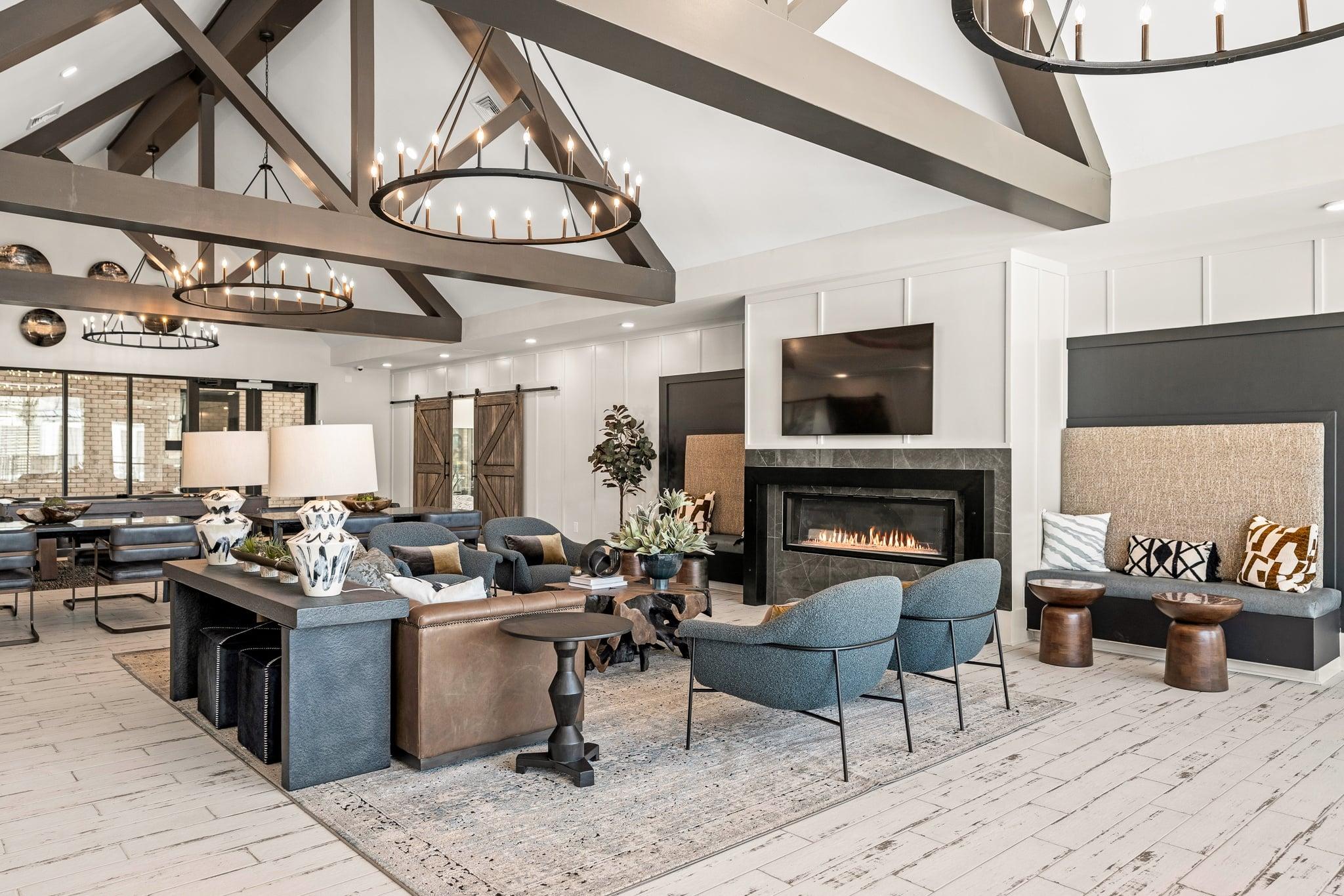 A modern living room with a fireplace and a large window.