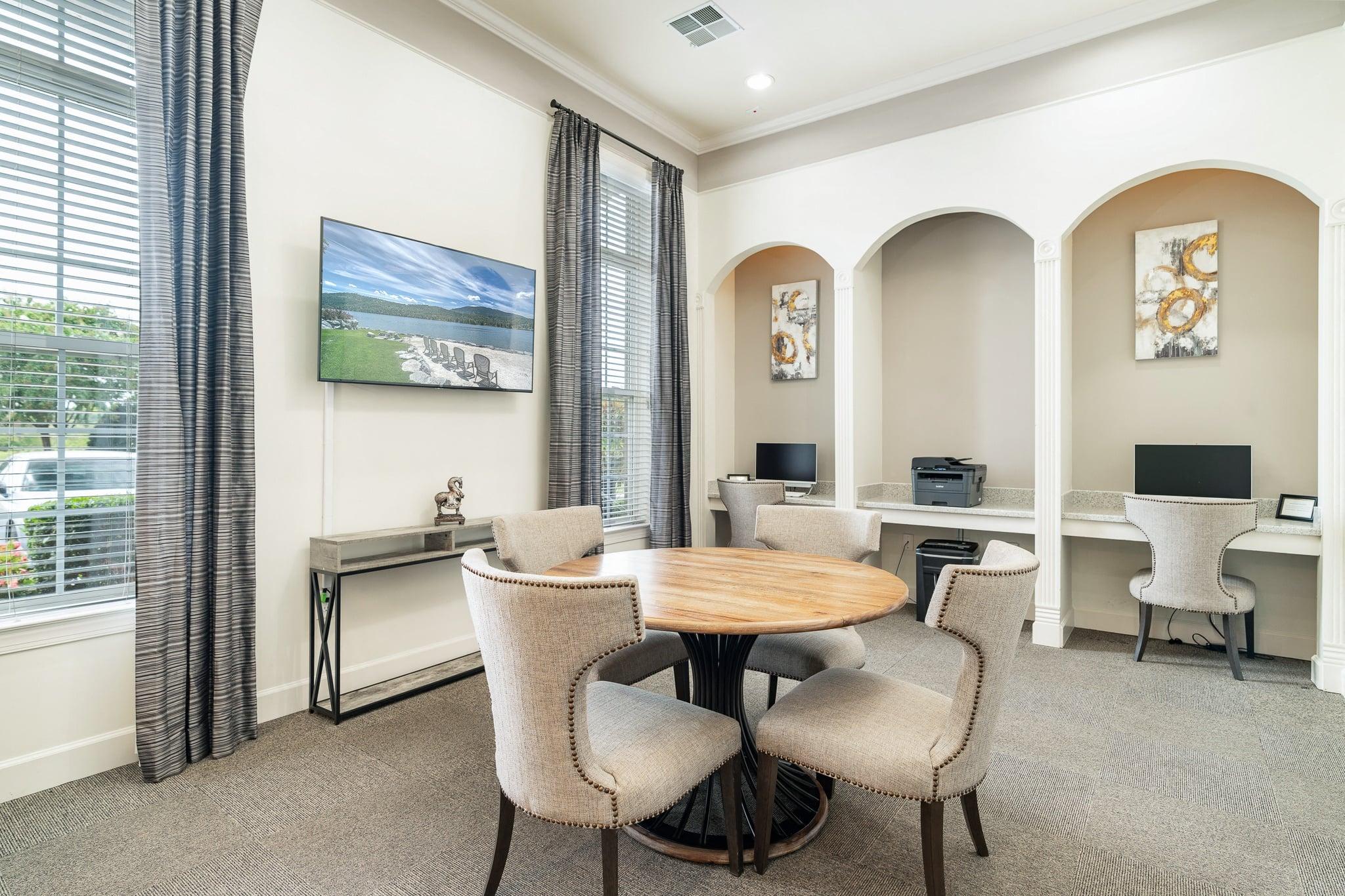 a conference room with a table and chairs and a television