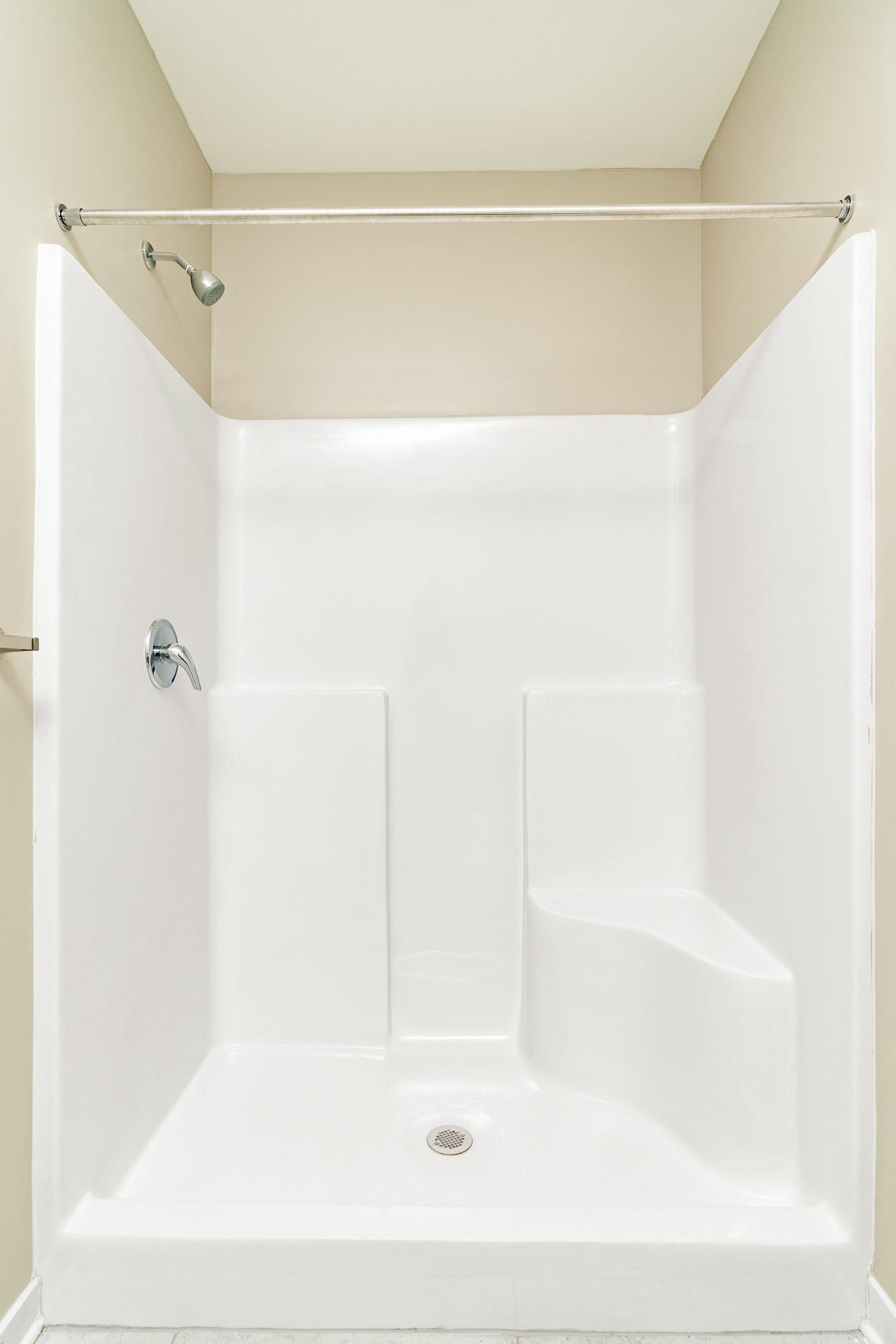a small bathroom with a shower and a sink