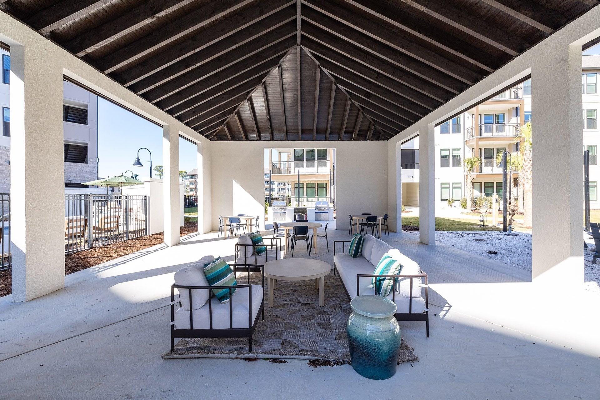 A patio with a table and chairs and a vase on it.