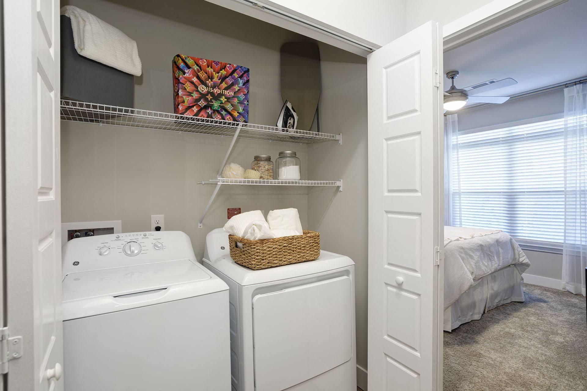 A small laundry room with a washer and dryer.