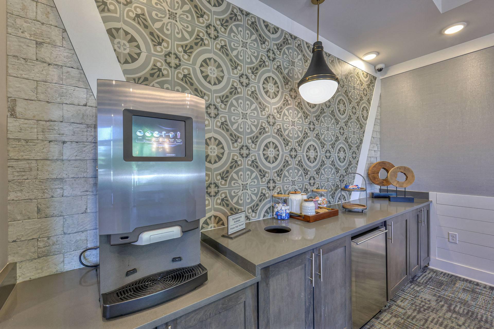A modern kitchen with a stainless steel coffee machine and a digital display on the counter.