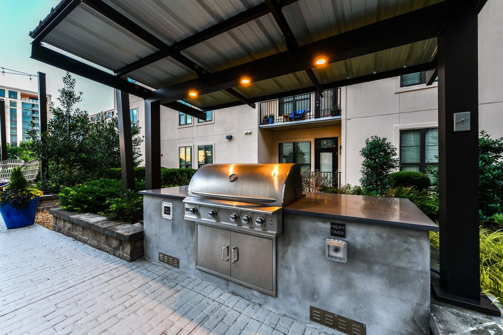 an outdoor kitchen with a stainless steel barbecue